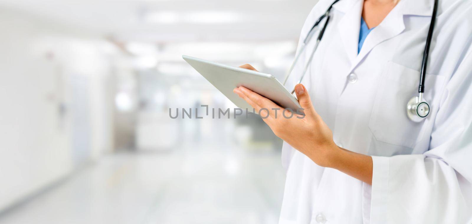 Doctor using tablet computer at the hospital. Medical healthcare and doctor staff service.