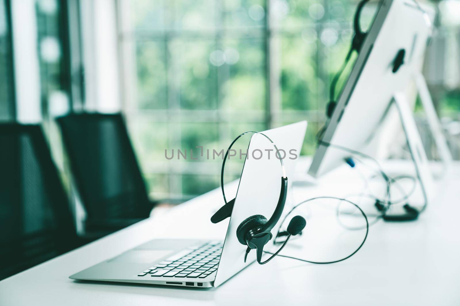 Headset and customer support equipment at call center ready for actively service by biancoblue
