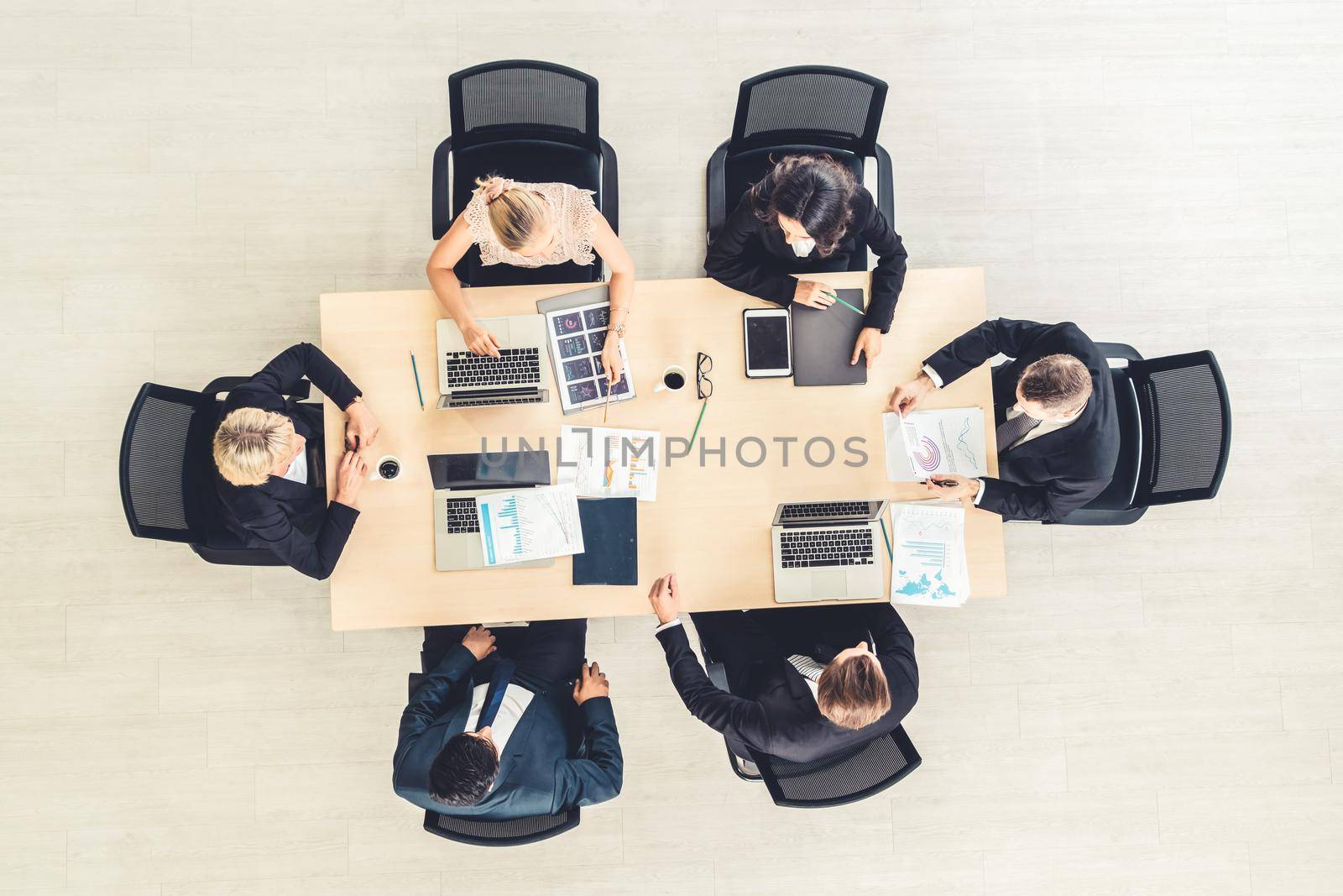 Business people group meeting shot from top view in office . Profession businesswomen, businessmen and office workers working in team conference with project planning document on meeting table .