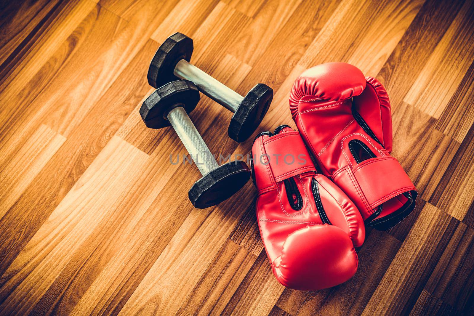 Red boxing gloves on wood background. Sport and healthy lifestyle concept.