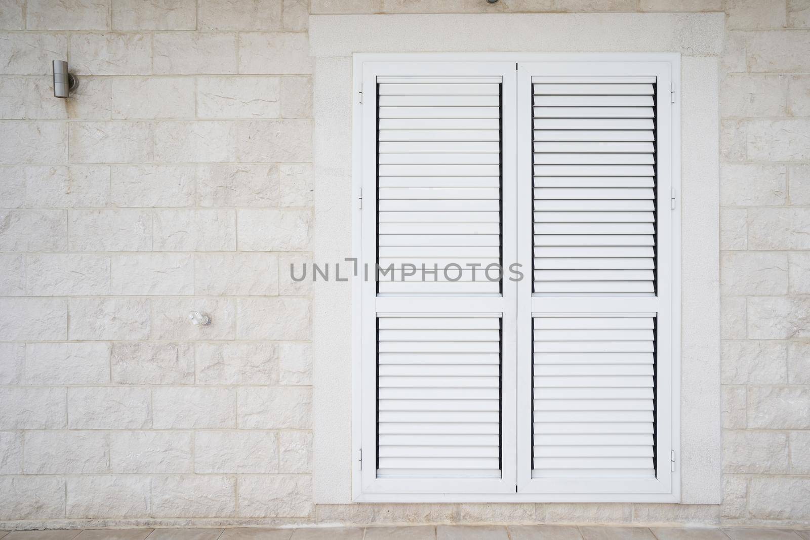 Plastic external window shutters on a residential building by iceberg
