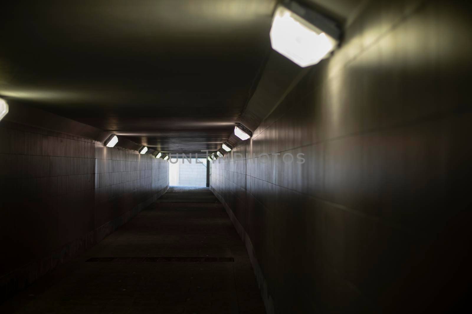 Tunnel with lamps. Long tunnel in building. by OlegKopyov