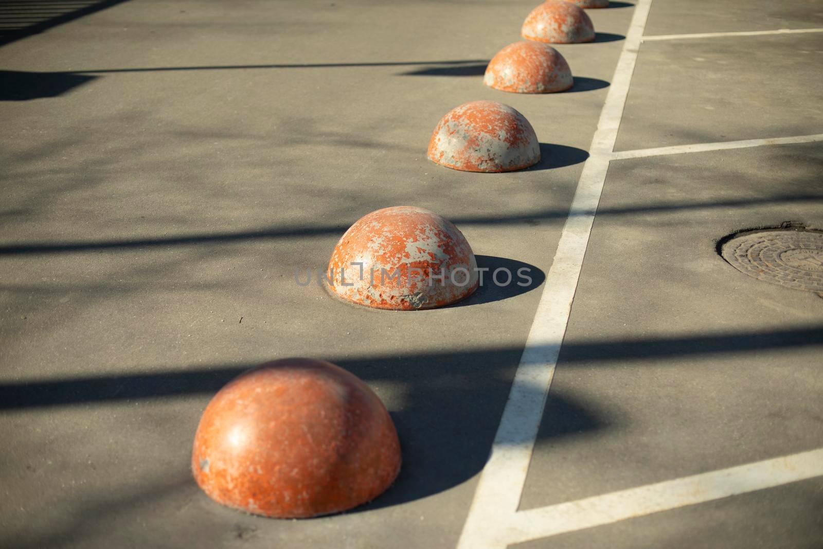 Limiter in parking lot, Sphere on road. Orange street fencing. by OlegKopyov