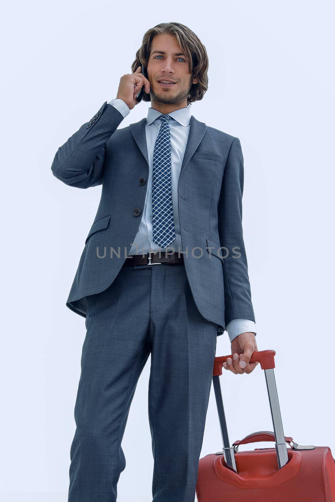 in full growth.businessman with travel suitcase talking on mobile.photo with copy space