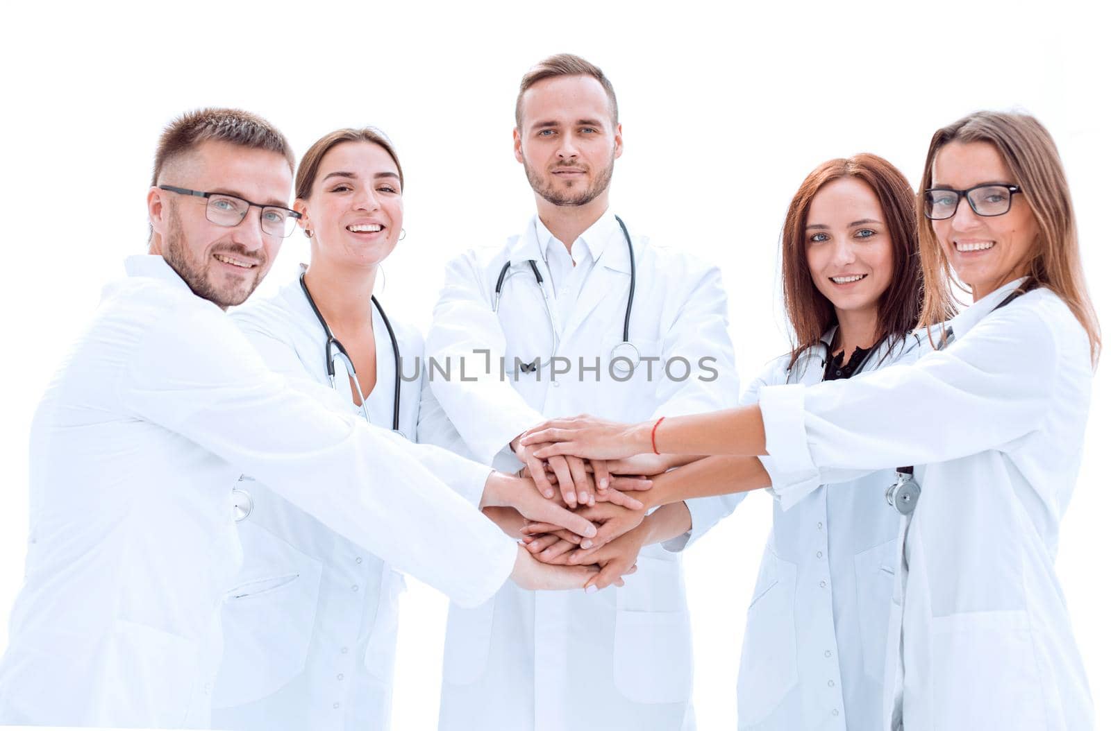 group of young doctors putting their palms together. by asdf