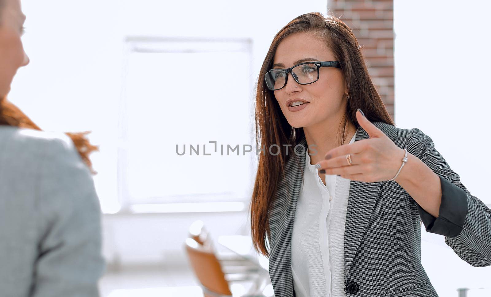 Manager talking with a client standing in the office .the concept of communication