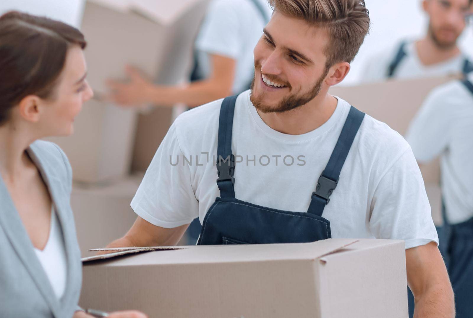 Businessman with documents, creating a stack of cardboard boxes.