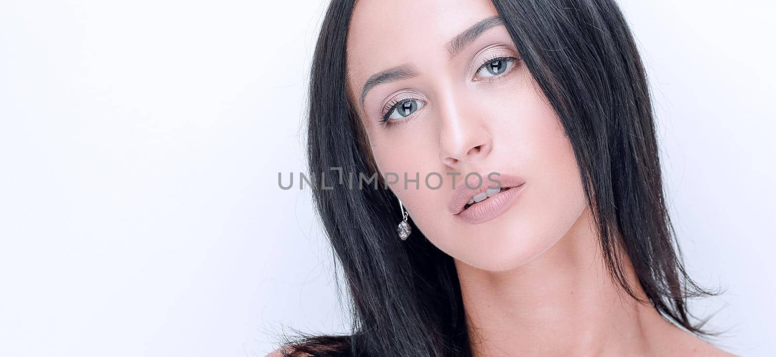 Beautiful young girl with natural make-up and perfect skin on a white background.