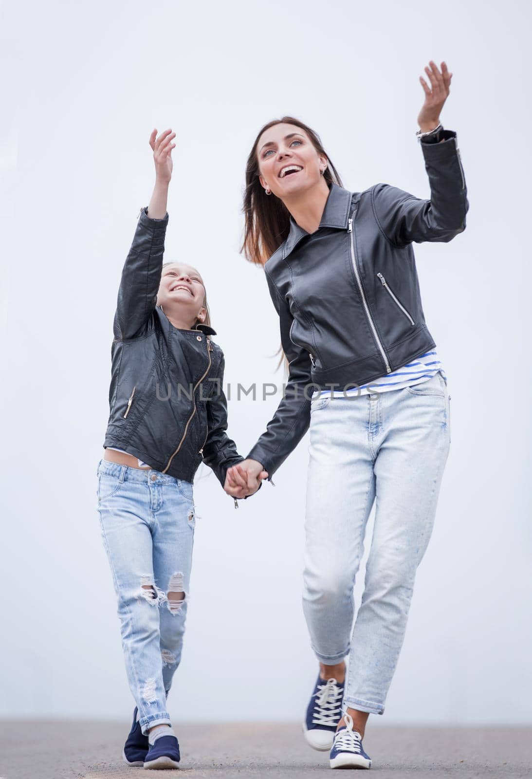 in full growth.happy mother and daughter walking together.photo with copy space