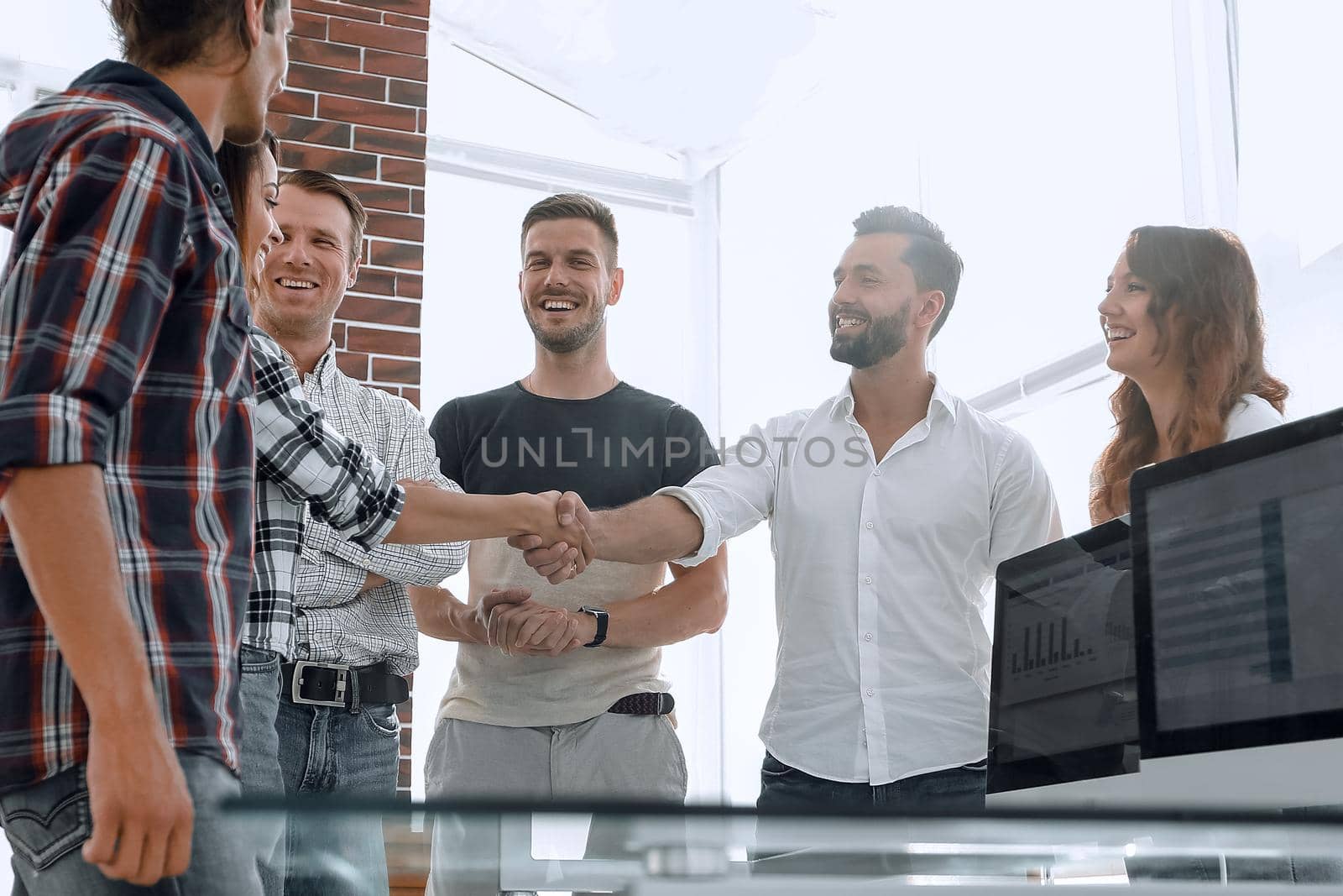 handshake partners in the creative office.photo with copy space