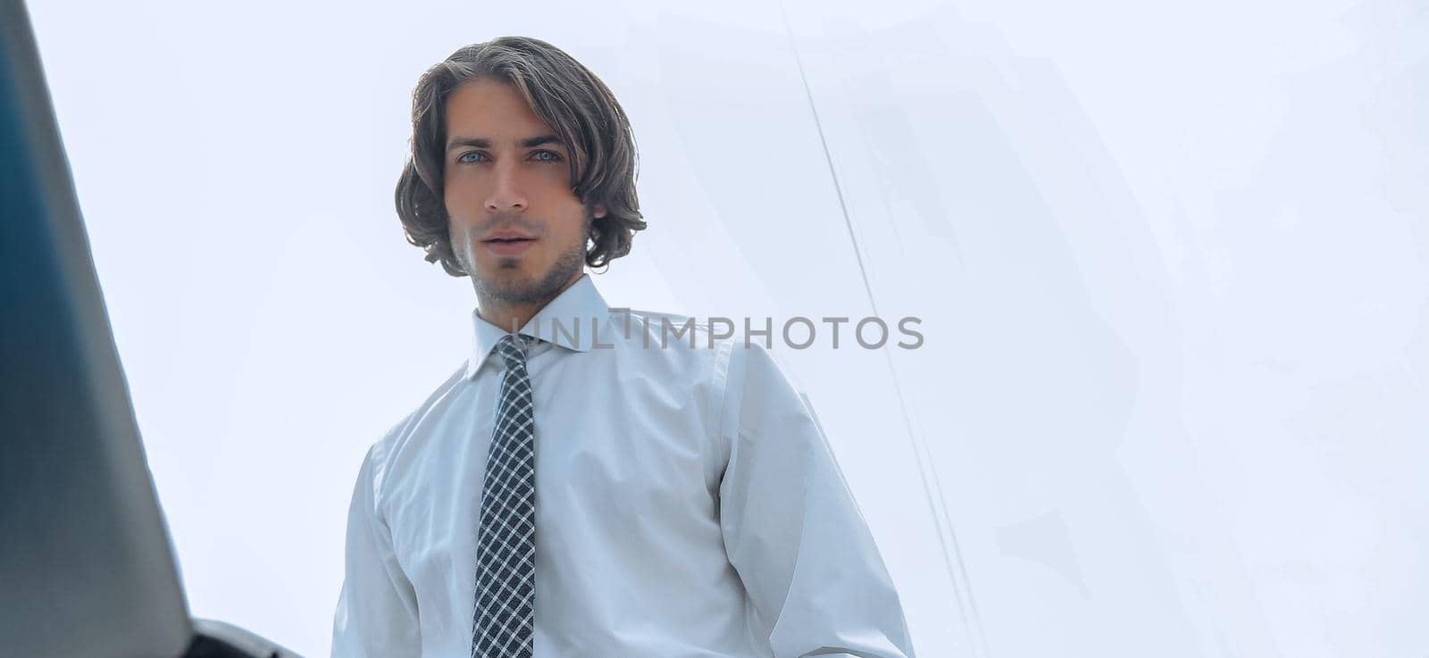 closeup.young businessman working on laptop.photo with copy space