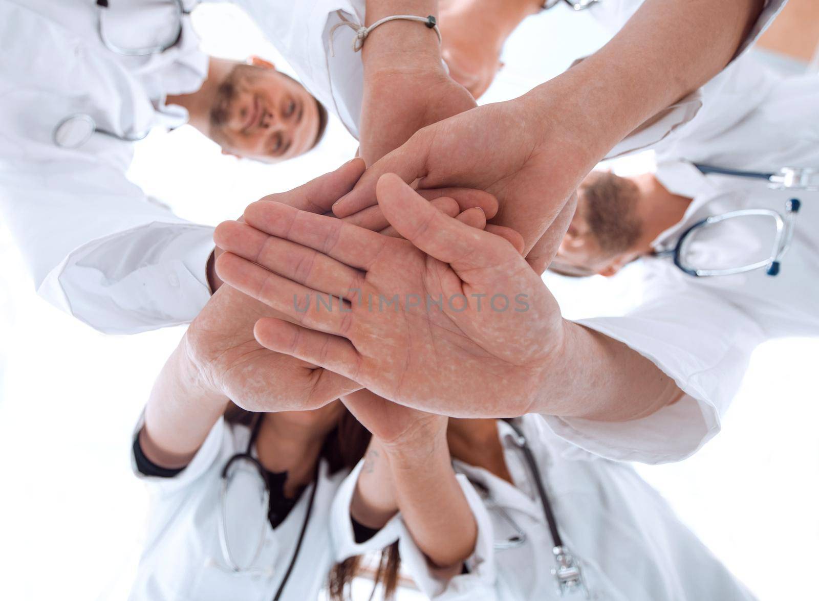 bottom view. image of a group of diverse medical staff showing their unity. concept of mutual aid.