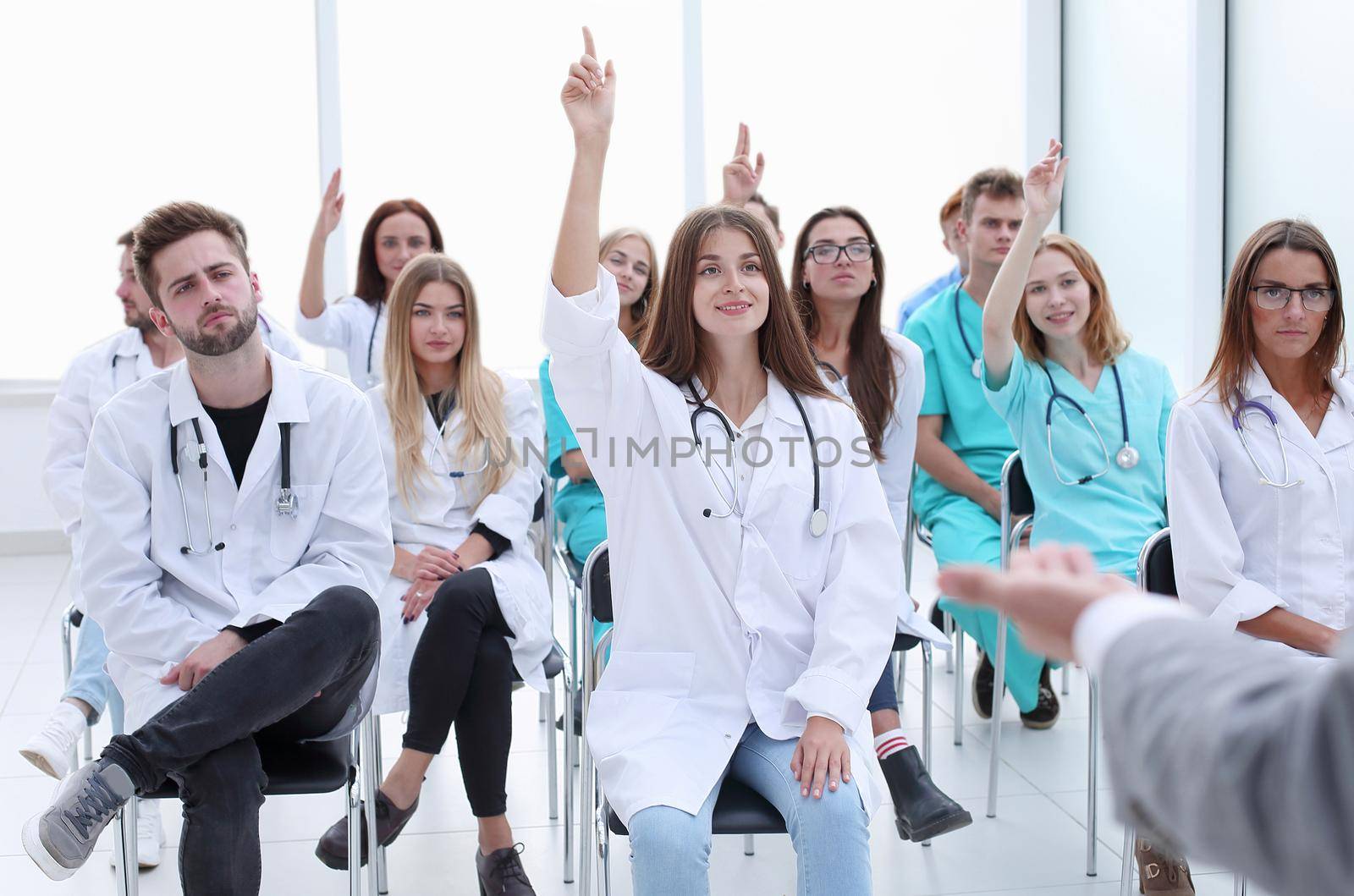 group of students asks questions at a medical seminar . photo with copy space