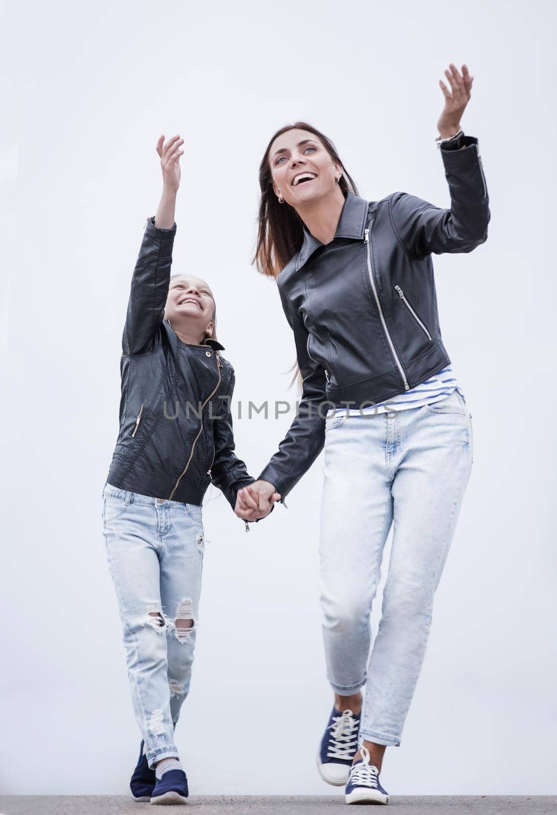 in full growth.happy mother and daughter walking together.photo with copy space