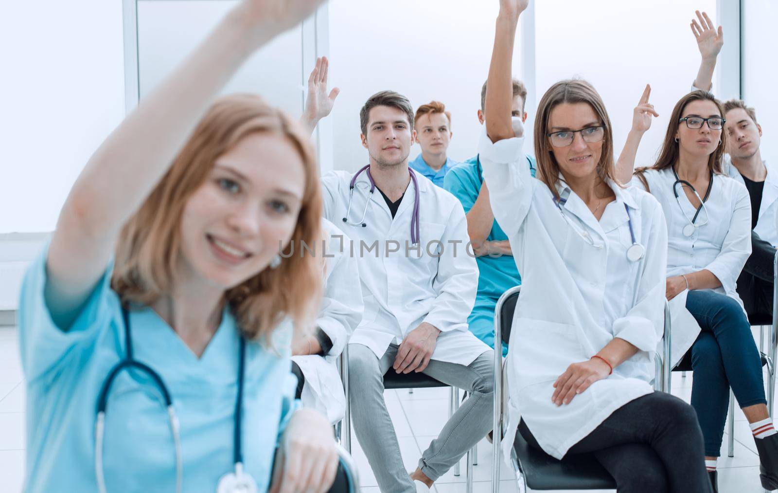 close up. young doctors raise their hands to ask questions. photo with copy space