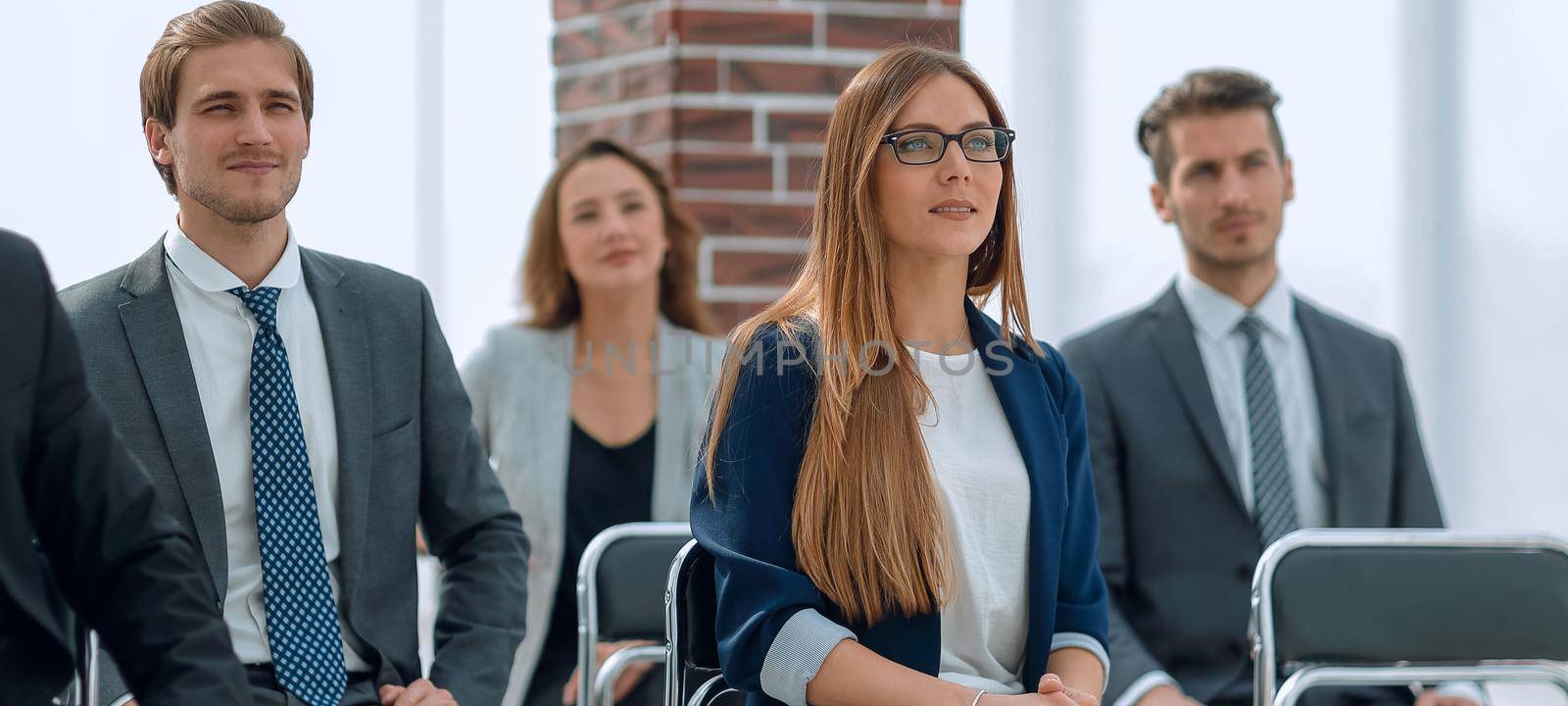 a group of professional workers is waiting for the beginning of the interview.