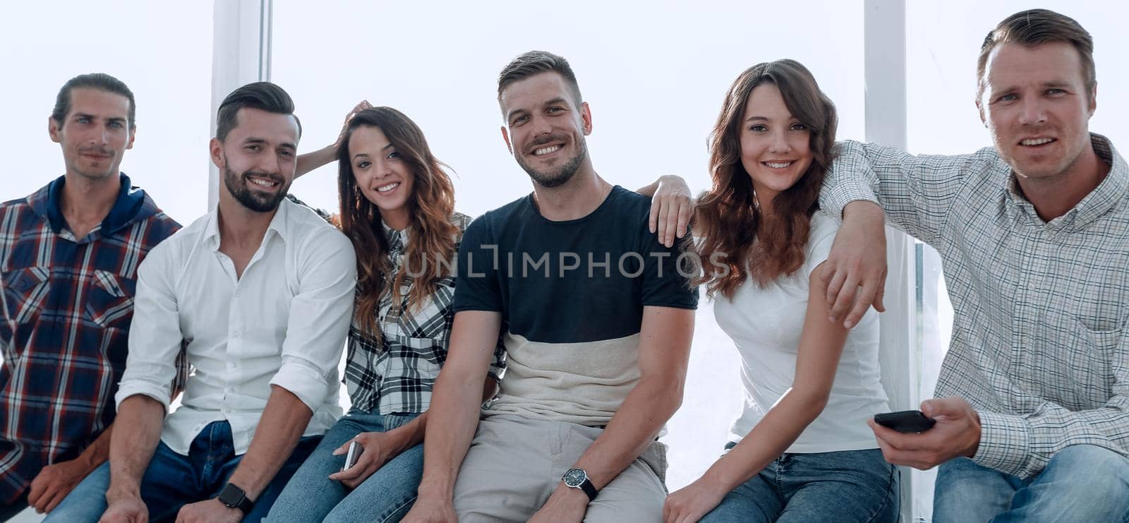 successful young people sitting on the windowsill.photo with copy space