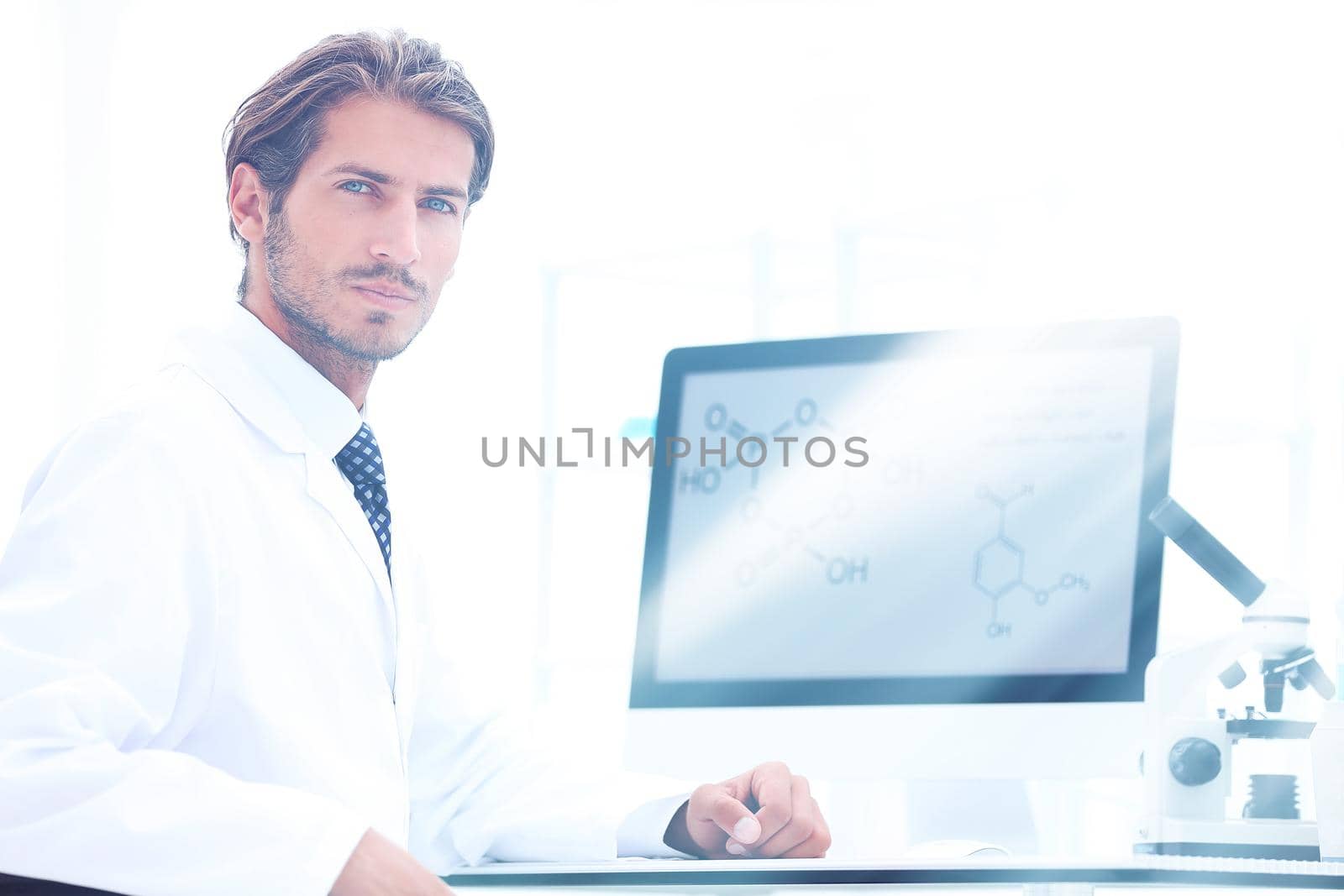 Portrait of a male doctor with a digital tablet in the medical office