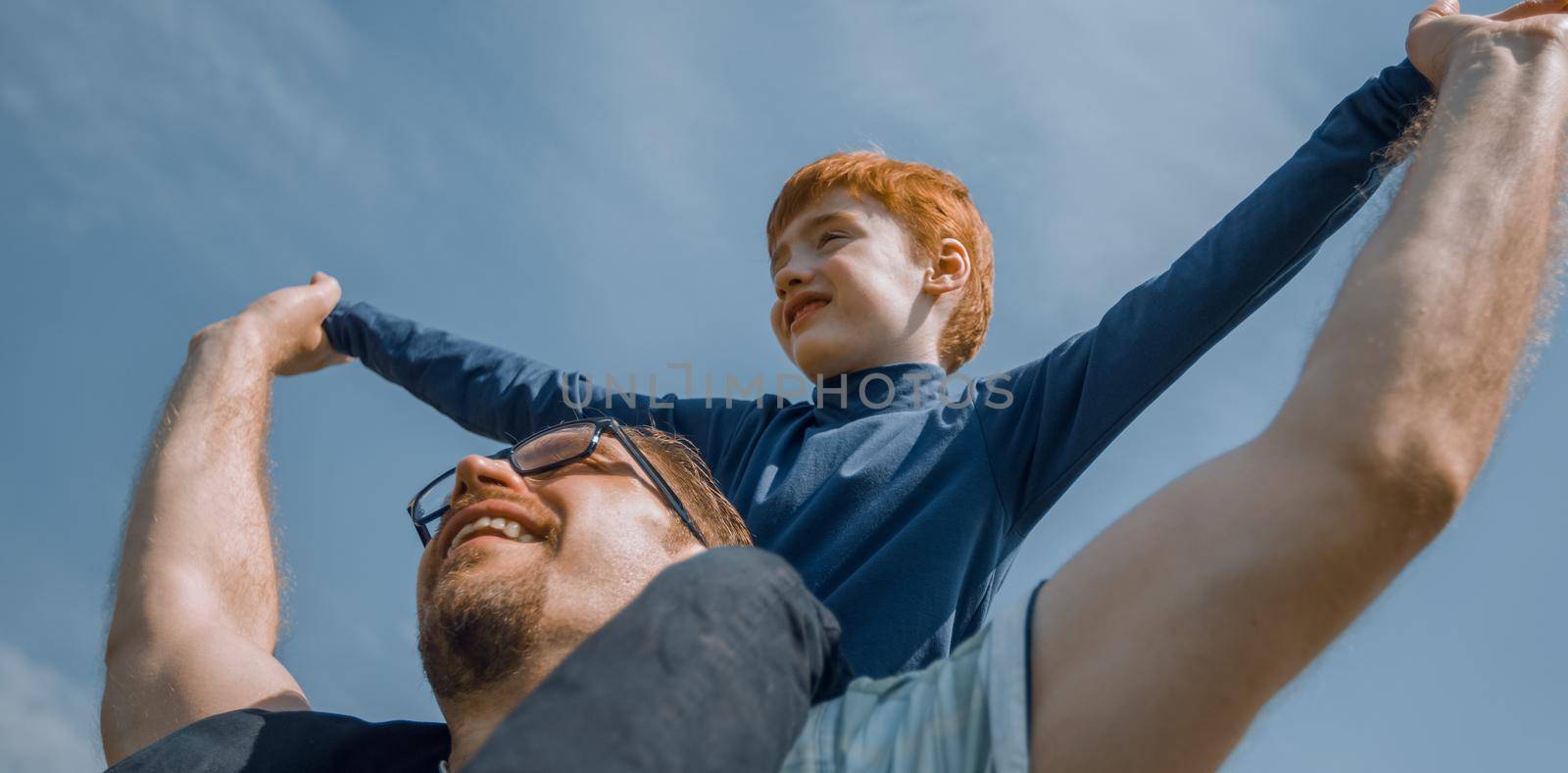 happy father has a little son on his shoulders.the concept of fatherhood