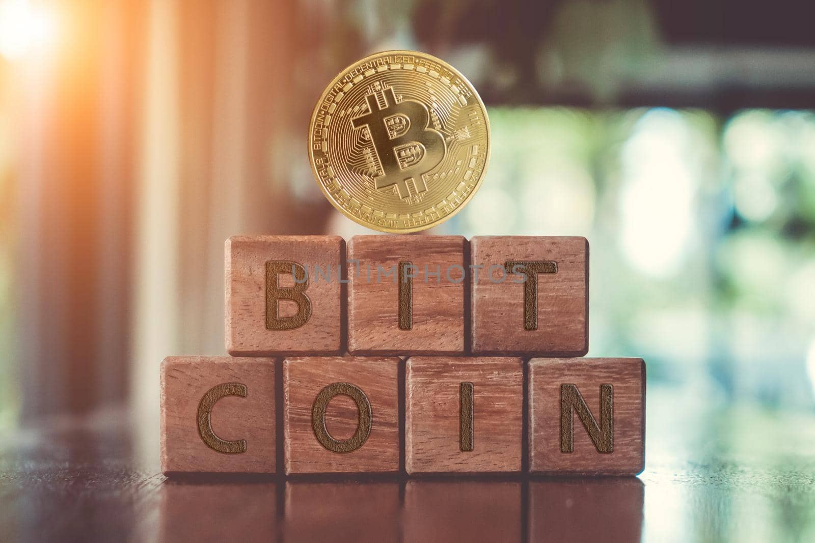 A group wooden cubes on table with word Bitcoin on it background.