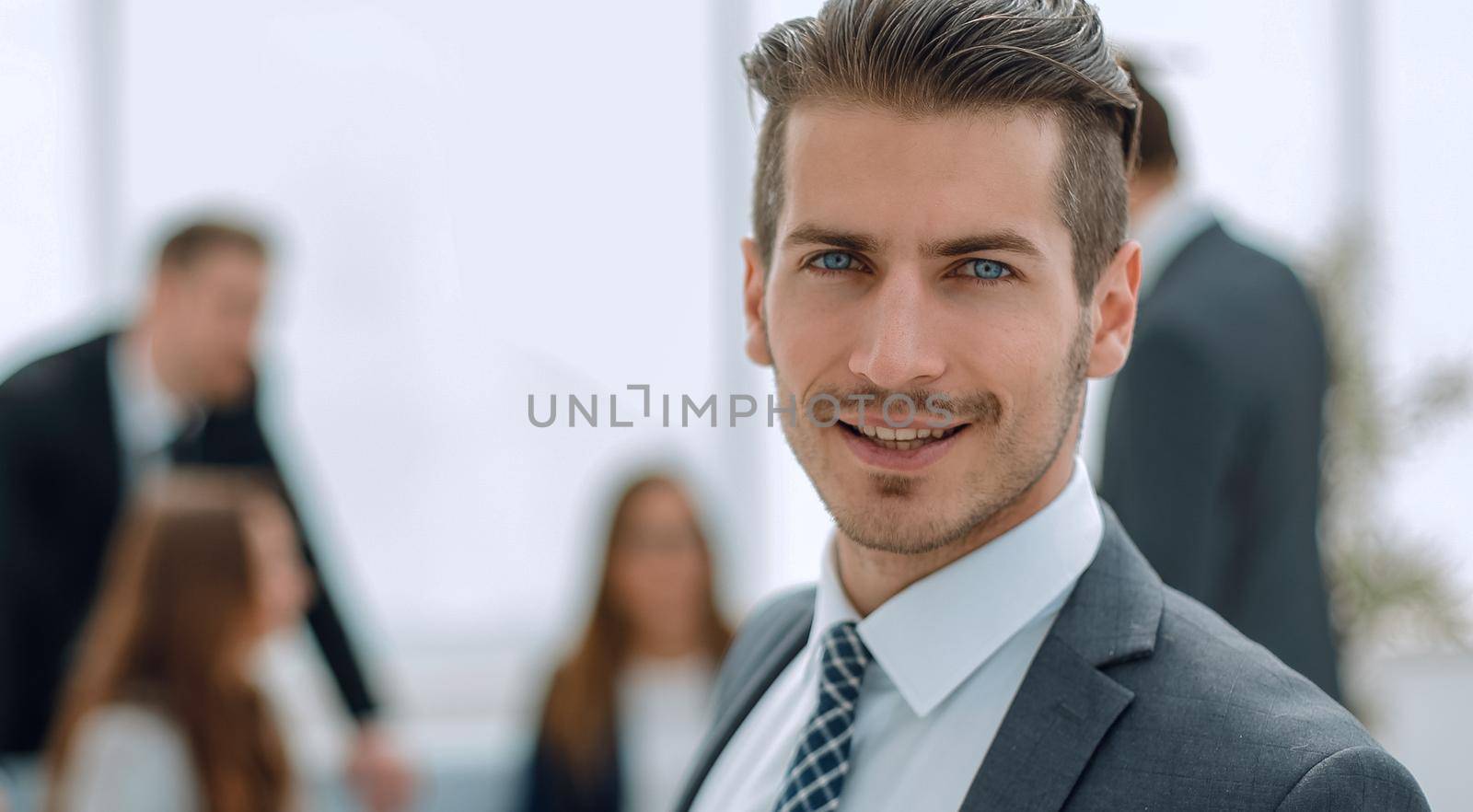 Young man in business suit smiling by asdf