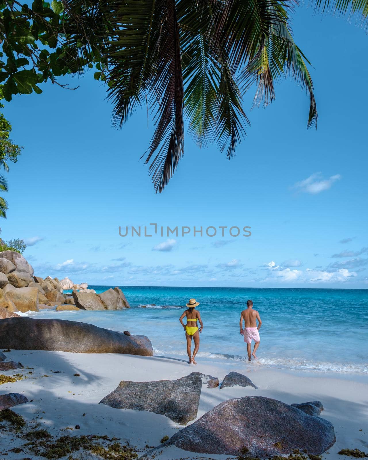 Anse Georgette Praslin Seychelles, young couple men and woman on a tropical beach during a luxury vacation in the Seychelles. Tropical beach Anse Georgette Praslin Seychelles by fokkebok