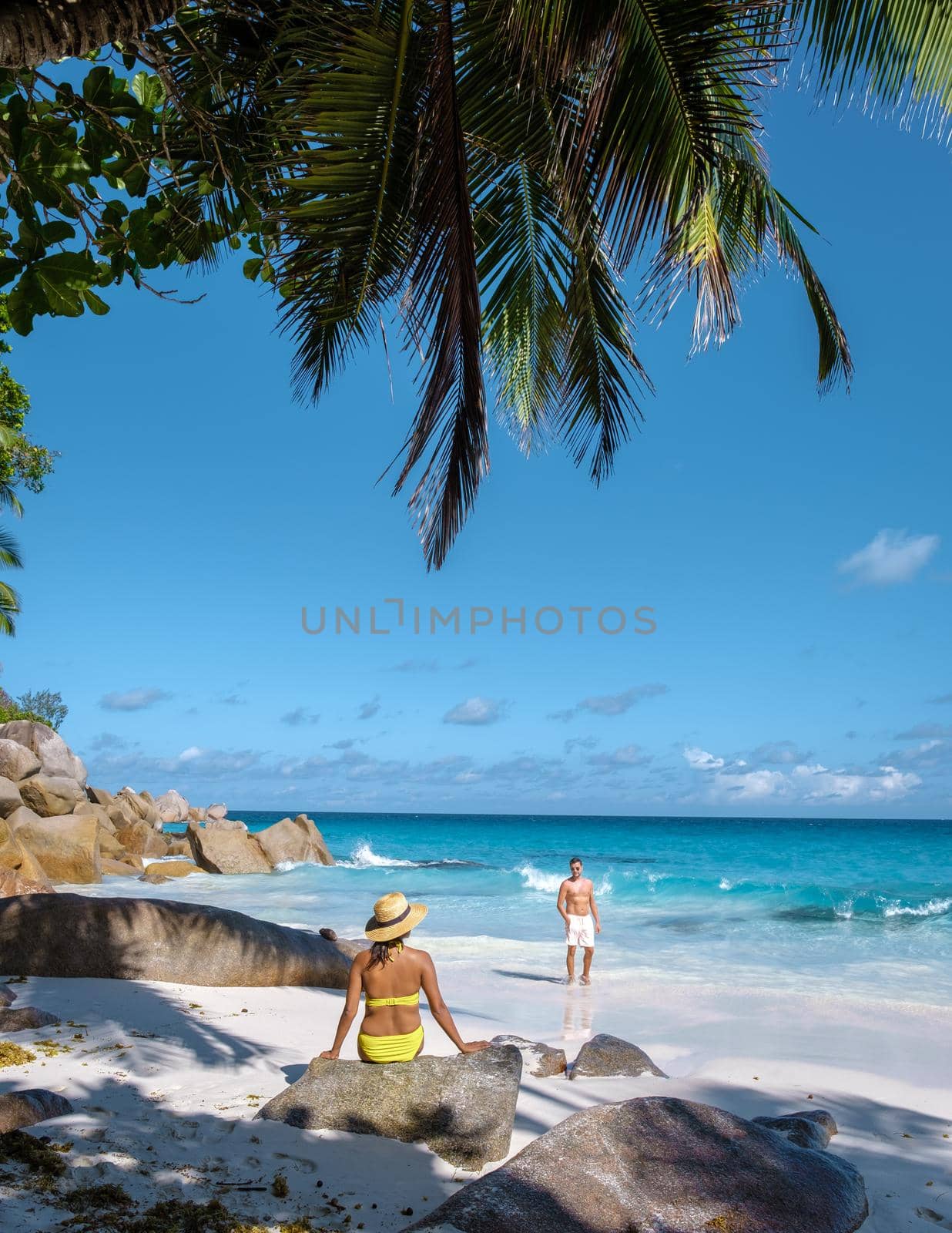 Anse Georgette Praslin Seychelles, young couple men and woman on a tropical beach during a luxury vacation in the Seychelles. Tropical beach Anse Georgette Praslin Seychelles by fokkebok