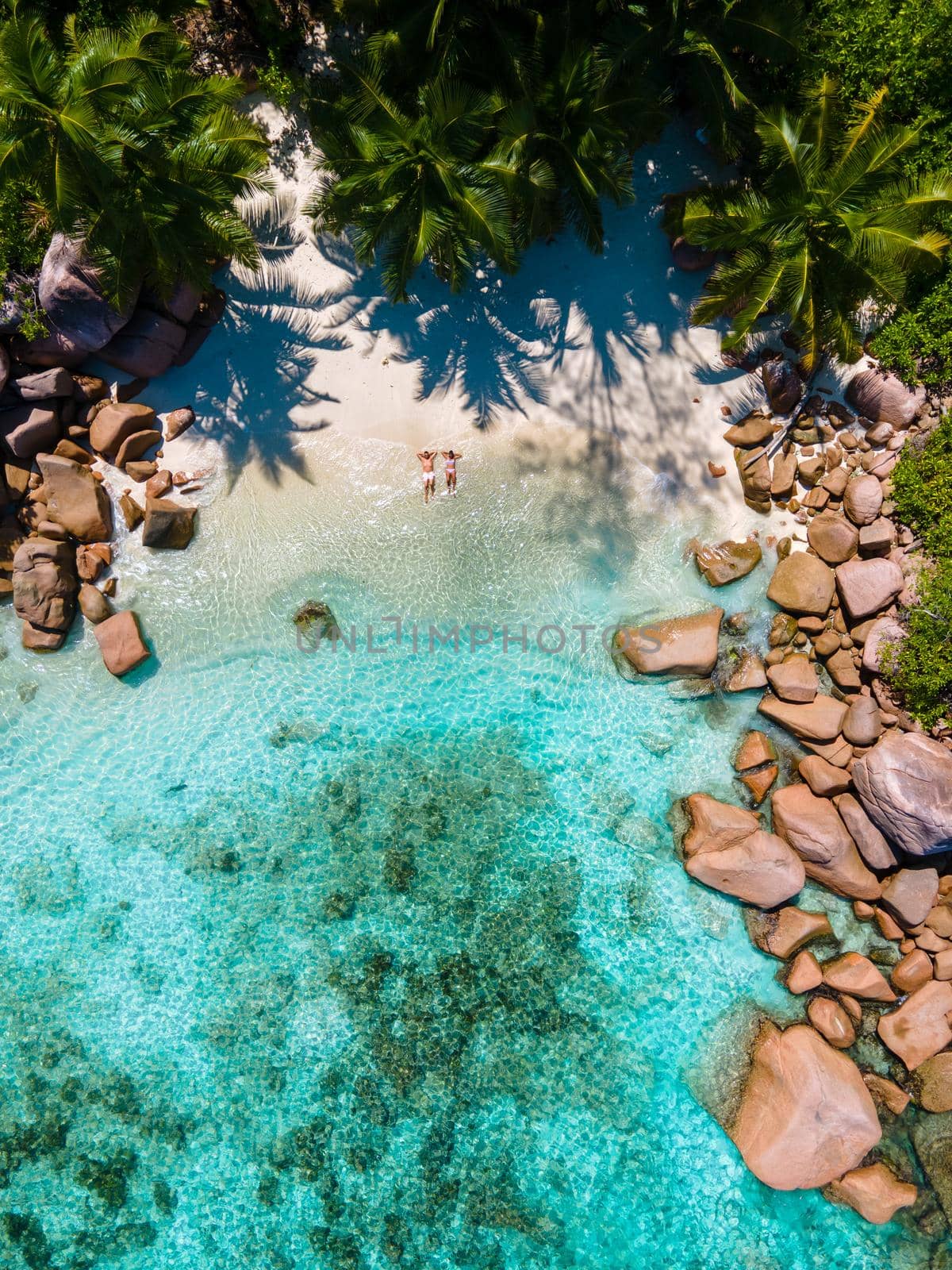 Anse Lazio Praslin Seychelles, young couple men and woman on a tropical beach during a luxury vacation in the Seychelles. Tropical beach Anse Lazio Praslin Seychelles by fokkebok