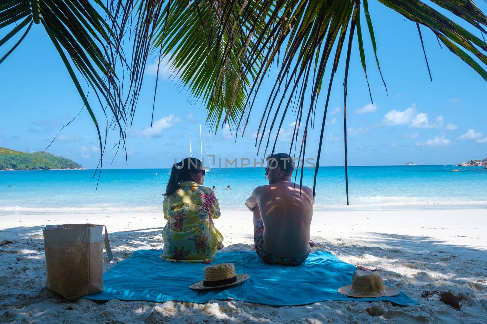 Anse Lazio Praslin Seychelles, young couple men and woman on a tropical beach during a luxury vacation in the Seychelles. Tropical beach Anse Lazio Praslin Seychelles by fokkebok