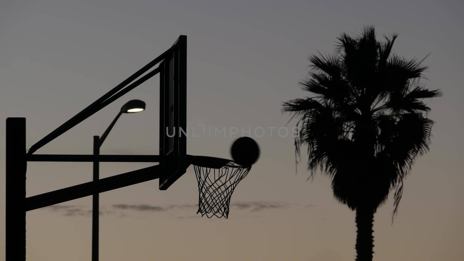 Hoop and net for basketball game silhouette. Basket ball court, California beach by DogoraSun