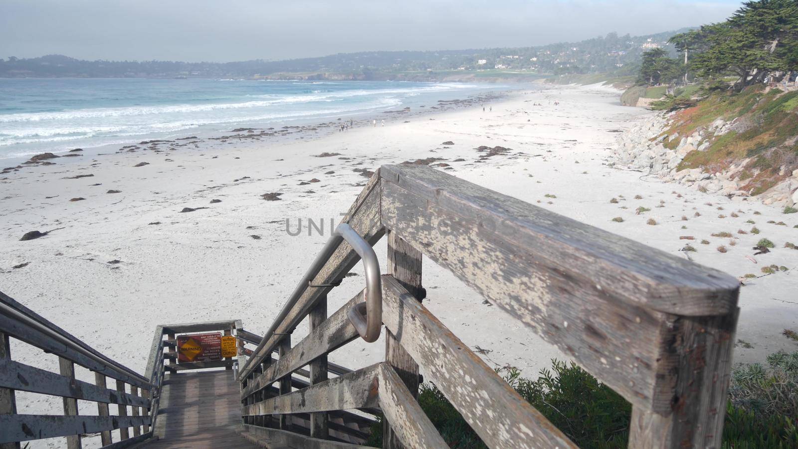 Ocean sandy beach, California coast, sea water wave crashing. Stairs or stairway by DogoraSun