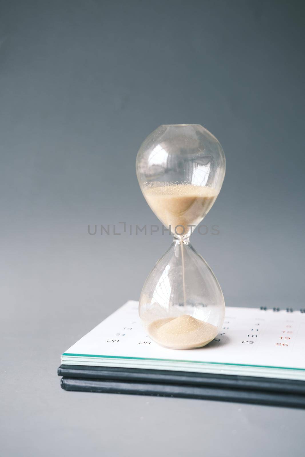 hourglass on table, Sand flowing through the bulb of Sandglass.