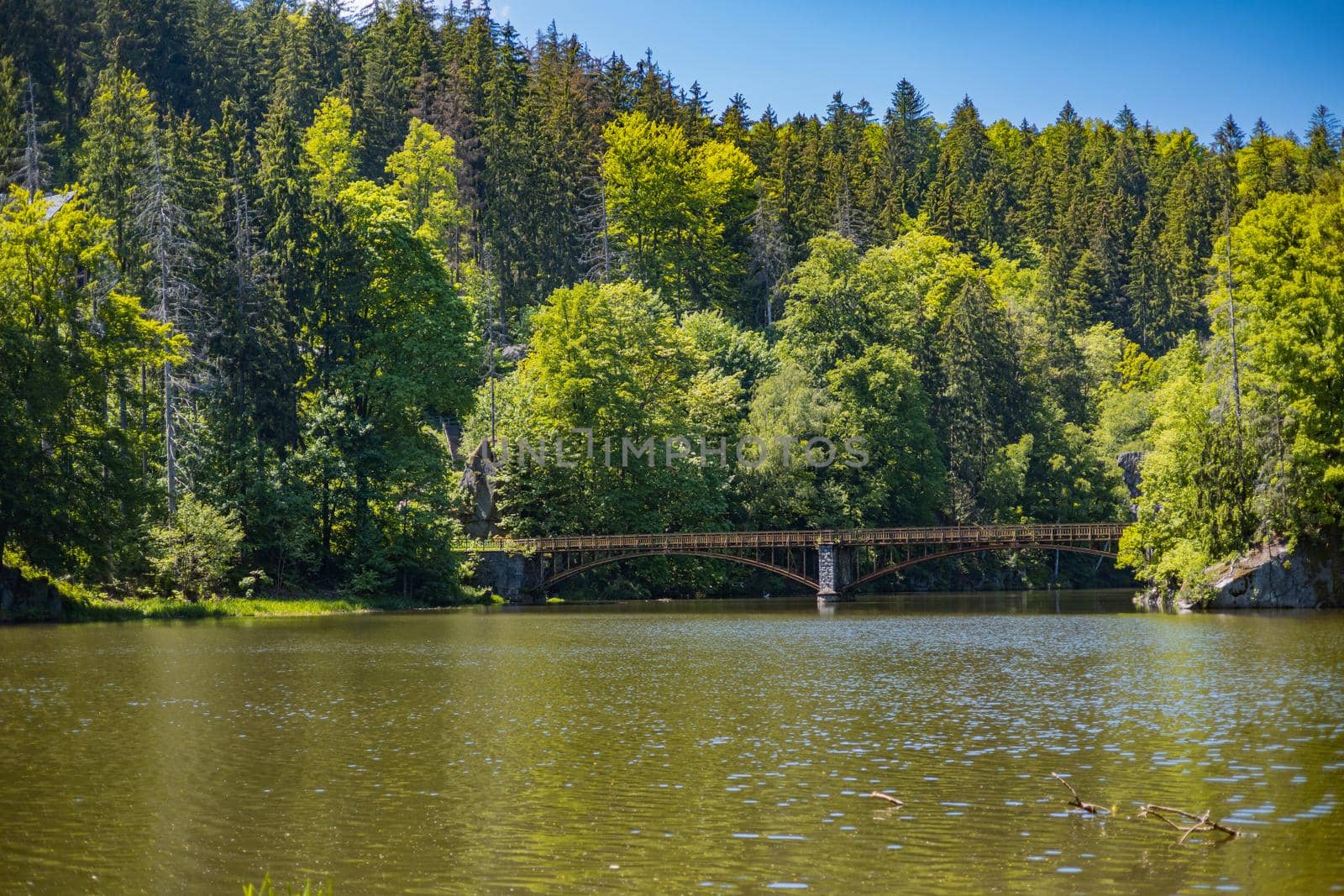 Long steel hanging footbridge over Modre lake by Wierzchu