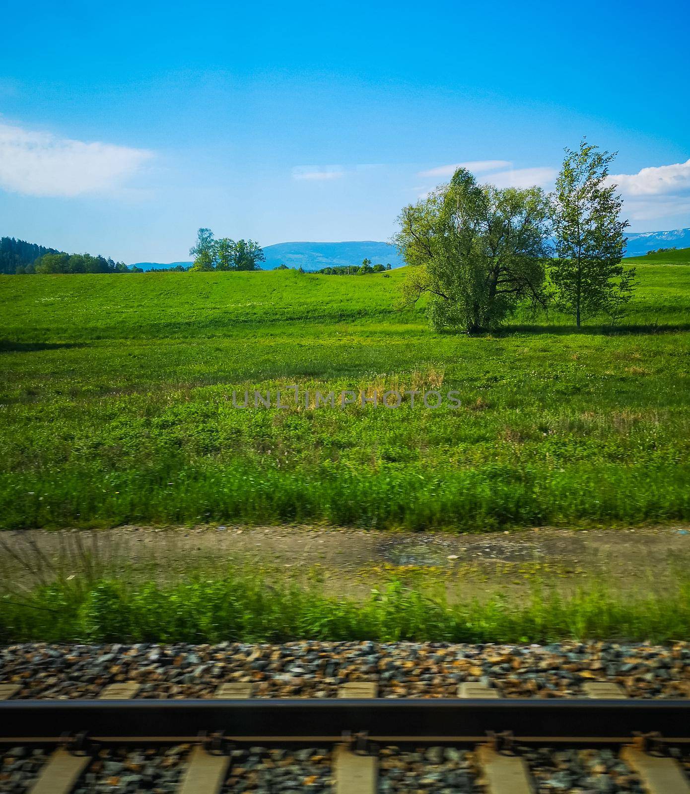 Beautiful view from running train to green hills