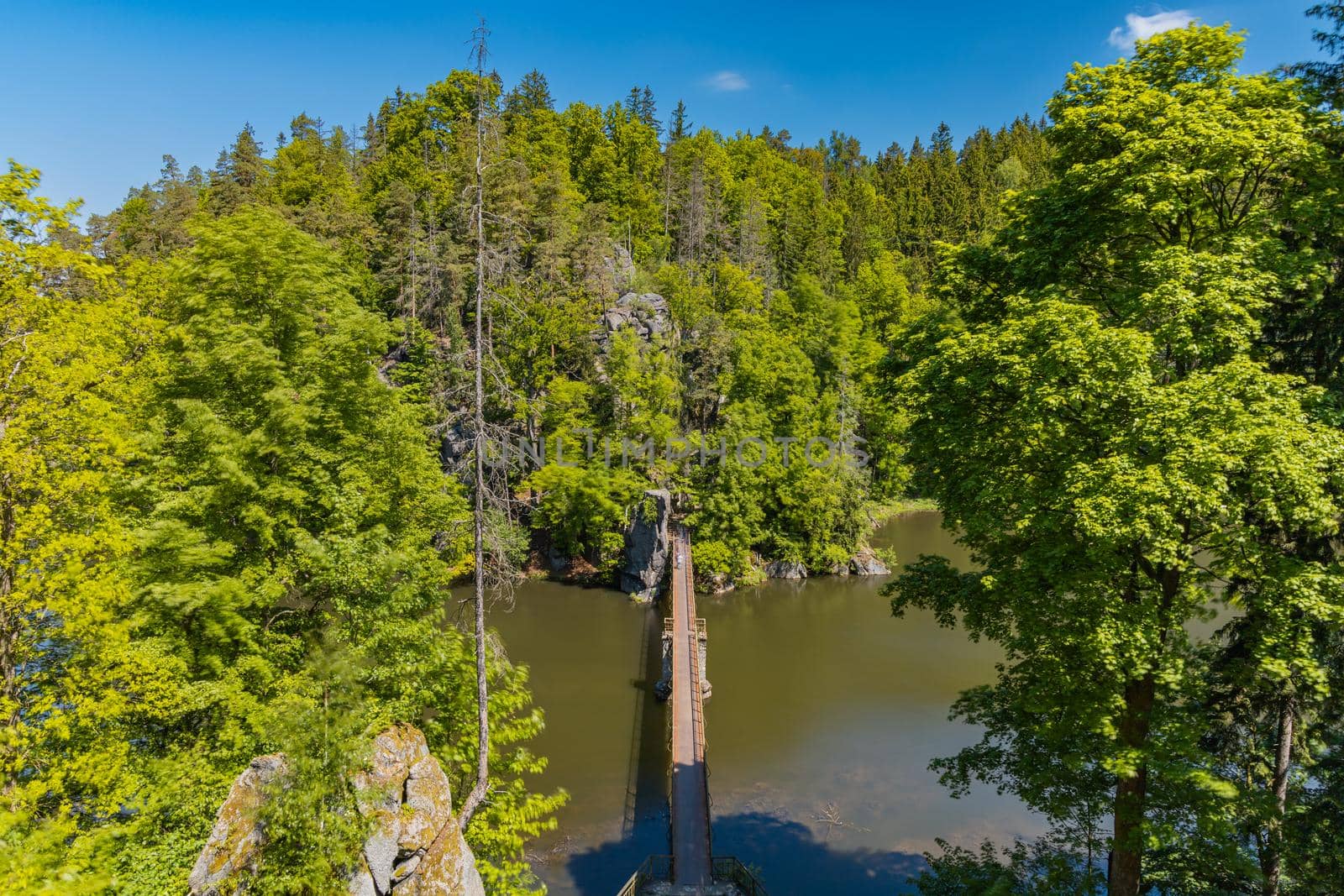 Long steel hanging footbridge over Modre lake by Wierzchu