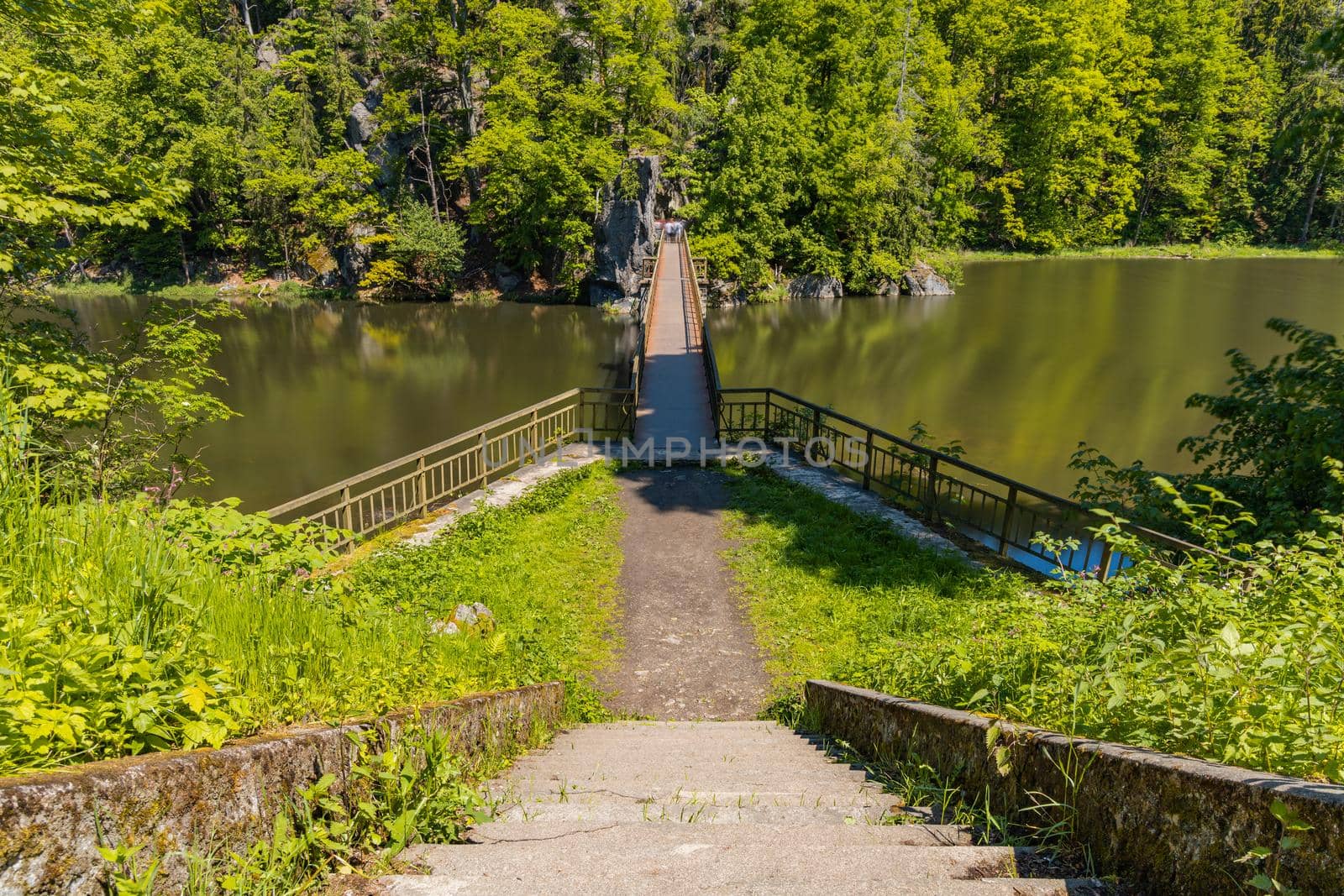 Long steel hanging footbridge over Modre lake