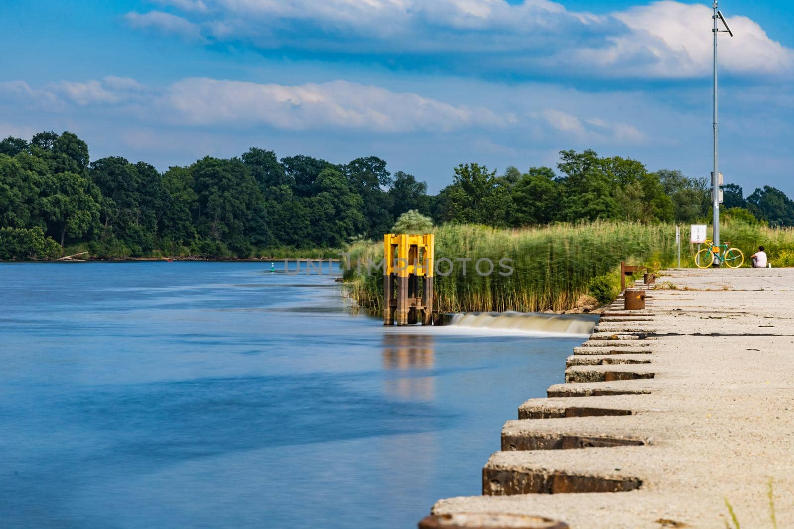 Silent river next to small wharf out of city center by Wierzchu