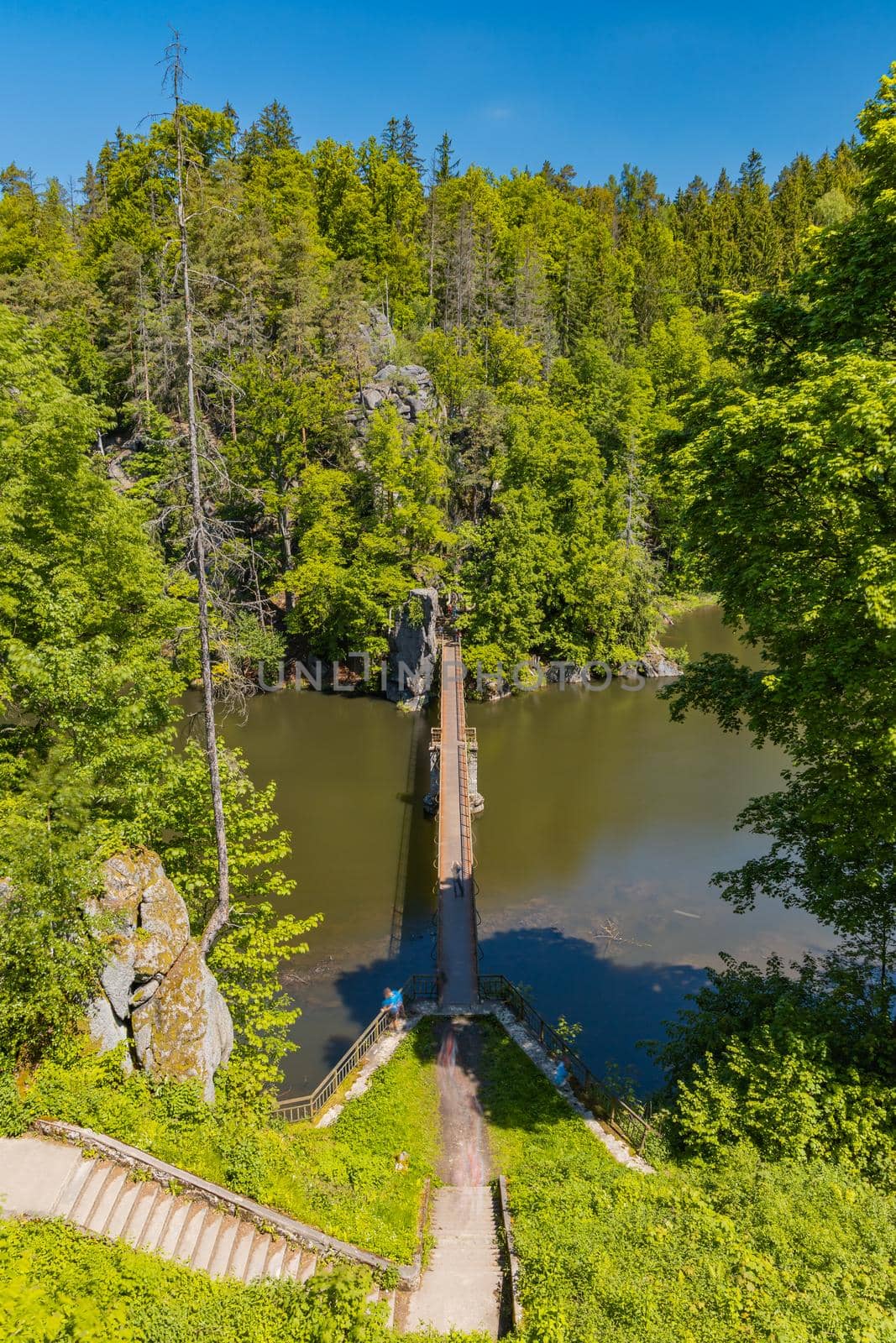 Long steel hanging footbridge over Modre lake