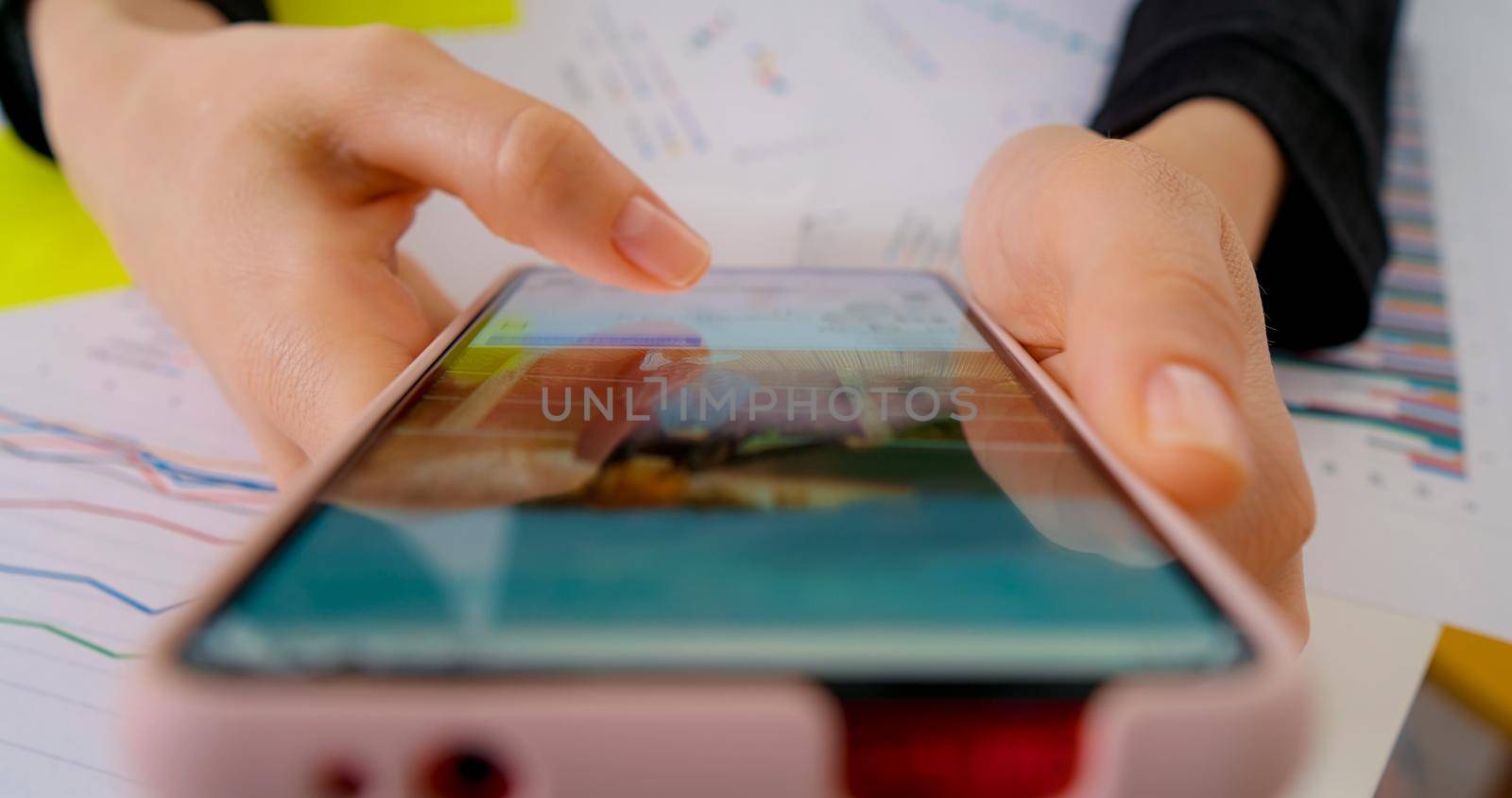 Person using smartphone, browsing through pictures on social network. Close-up Macro. Finger scrolling social media app feed, information search.