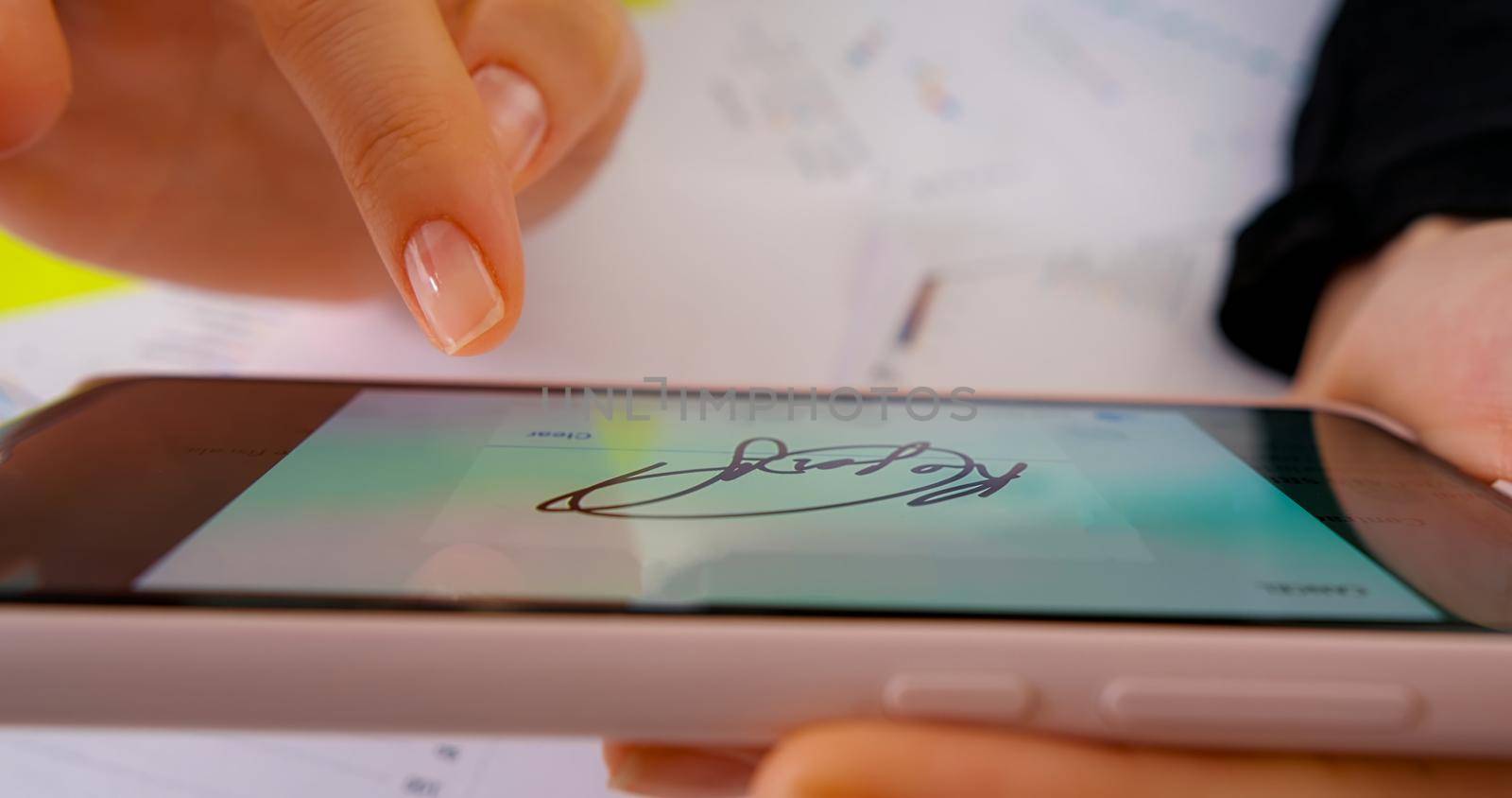 Close up Digital Signature on smartphone. Close up business office.