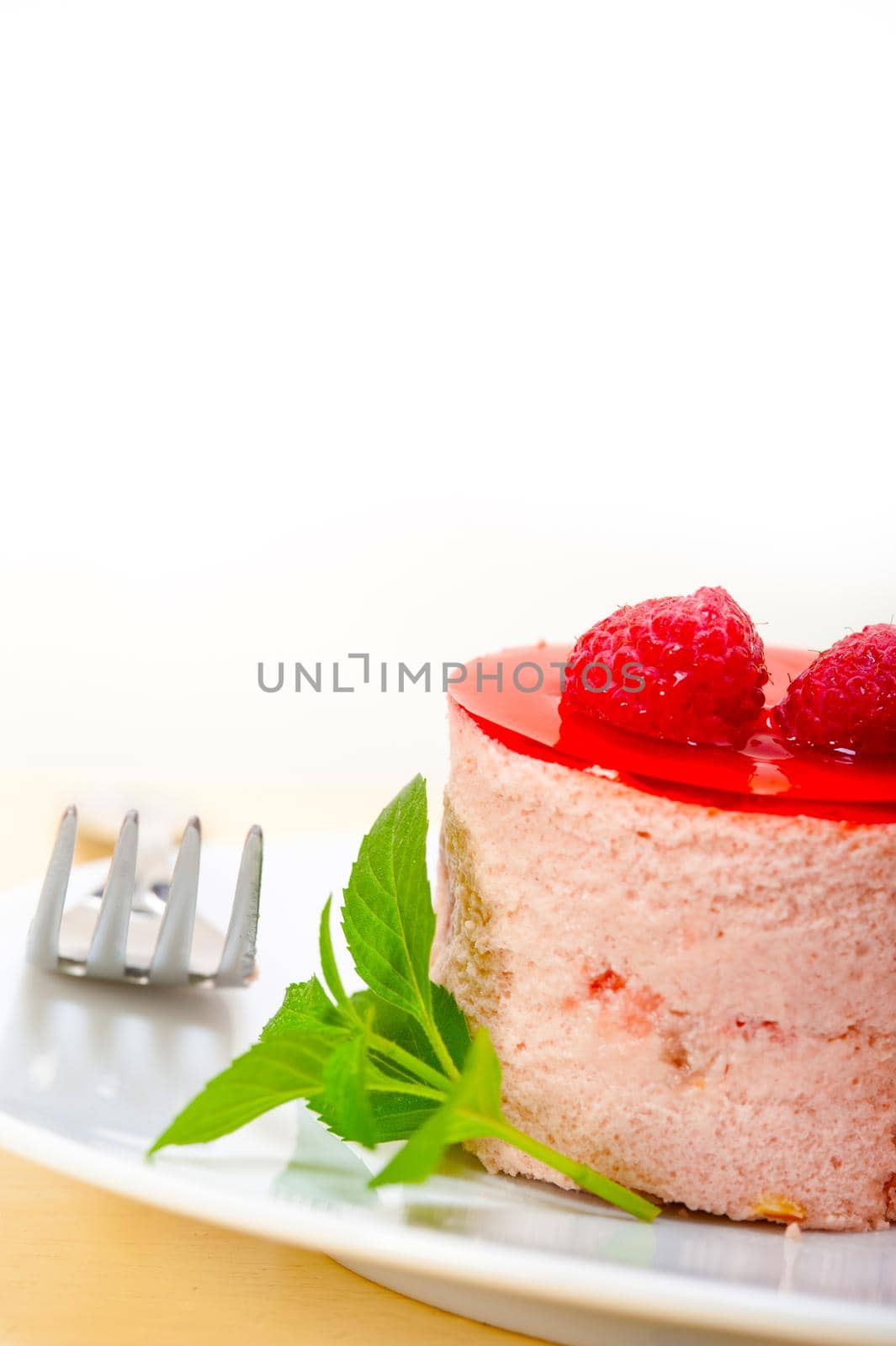 fresh raspberry cake mousse dessert round shape with mint leaves