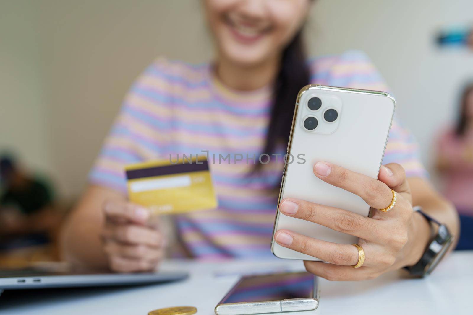 Online Shopping and Internet Payments, Portrait of Beautiful Asian women are using their credit cards and mobile phones to shop online or conduct errands in the digital world.