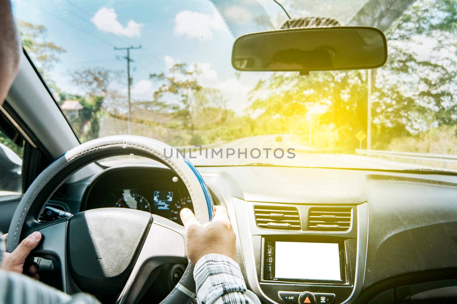 Concept of hands on the wheel of a car, Man's hands on the wheel of the car, Close up of person driving with hands on the wheel, inside view of a man driving a car