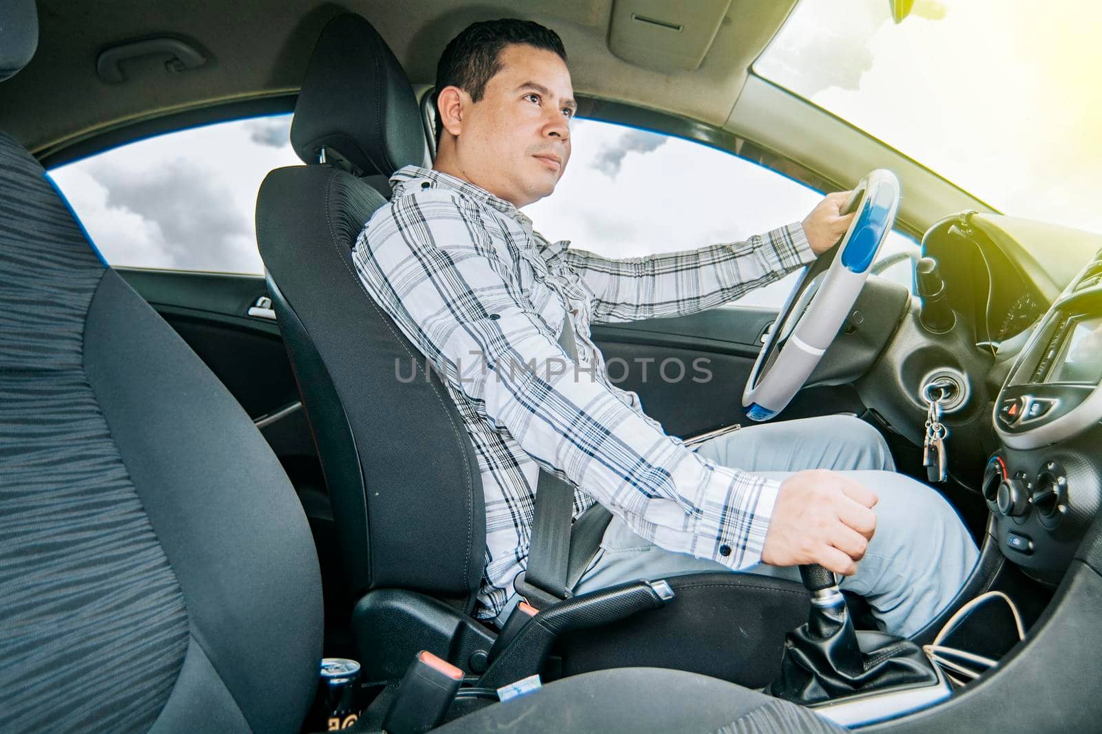 A happy man driving a car, Side view of a man driving a car, interior view of a young man driving a car, concept of man brand new car