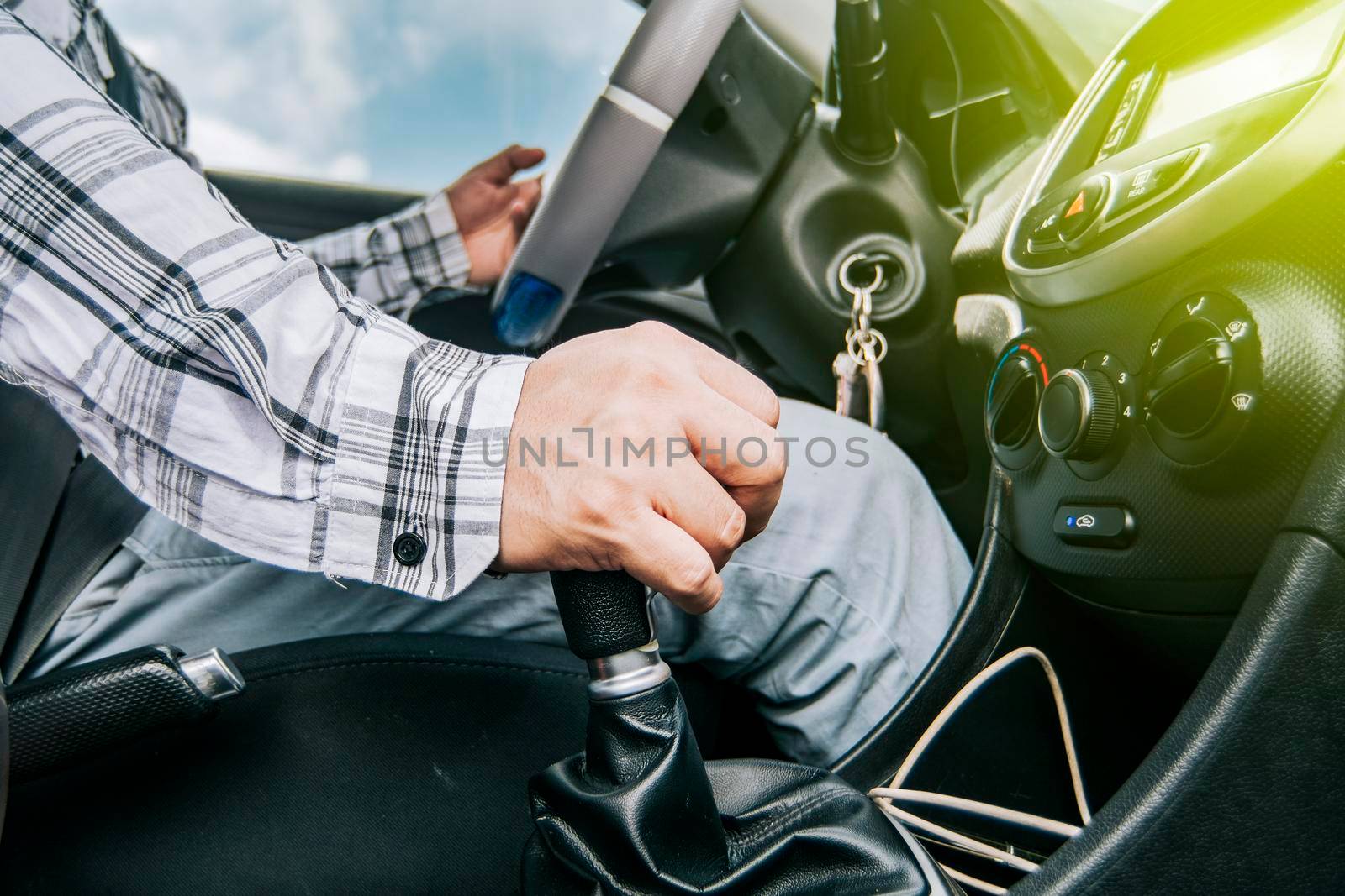 Close up of a man's hand on the gear lever of a car, concept of speed and gear lever, close up of hands accelerating on the gear lever