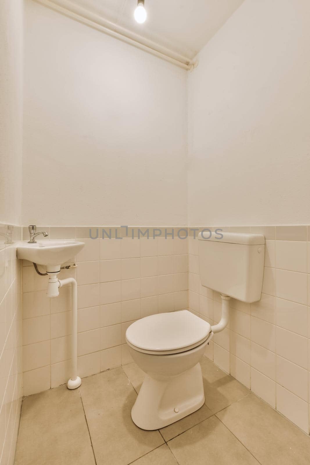 Simple toilet with small sink by casamedia