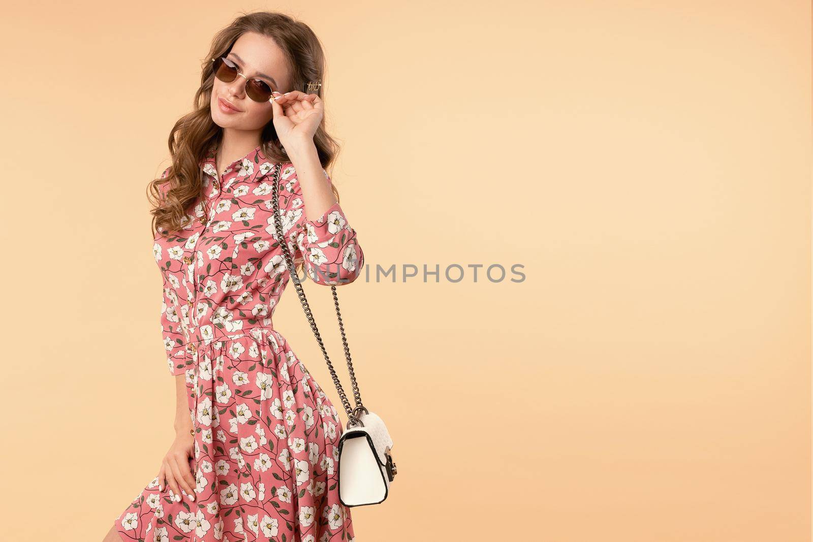 Sweet and charming girl in pretty summer dress with handbag and sunglasses. by StudioLucky
