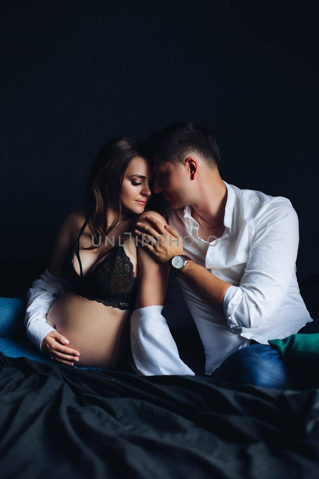 Gorgeous couple with pregnant woman. Man touching her shoulder. by StudioLucky