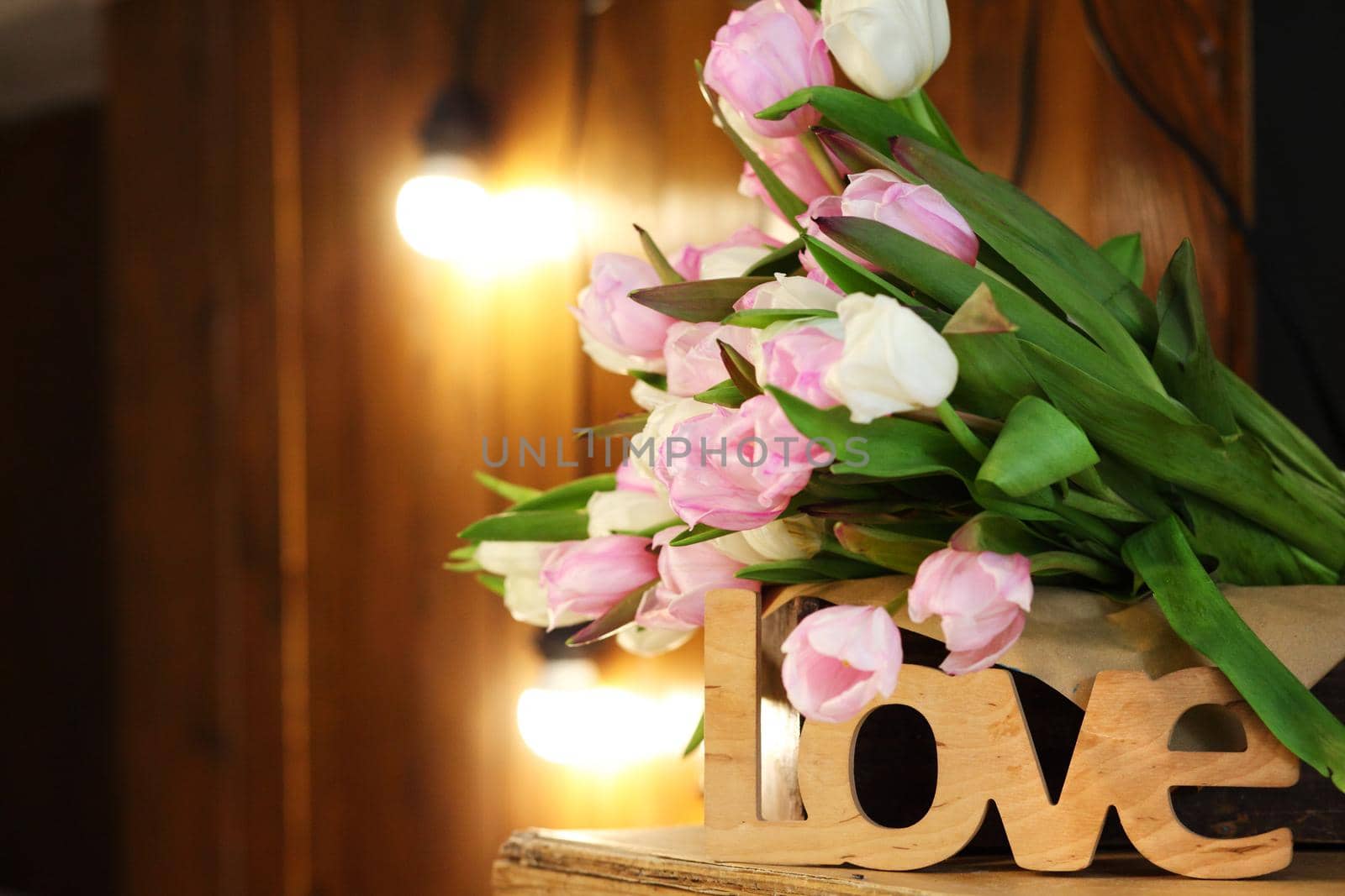 Bouquet of tulips on a wooden rustic table. Spring holidays concept background.