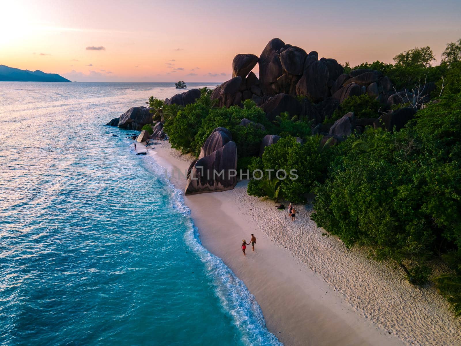 Anse Source d'Argent, La Digue Seychelles, young couple men and woman on a tropical beach during a luxury vacation in the Seychelles. Tropical beach Anse Source d'Argent, La Digue Seychelles by fokkebok